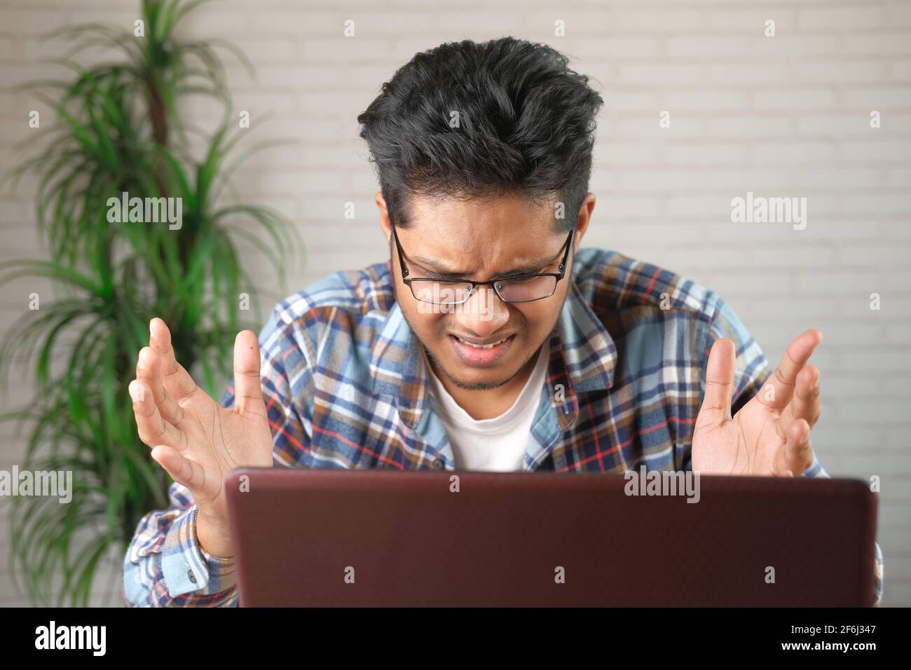 young stressed businessman working on laptop  Stock Photo