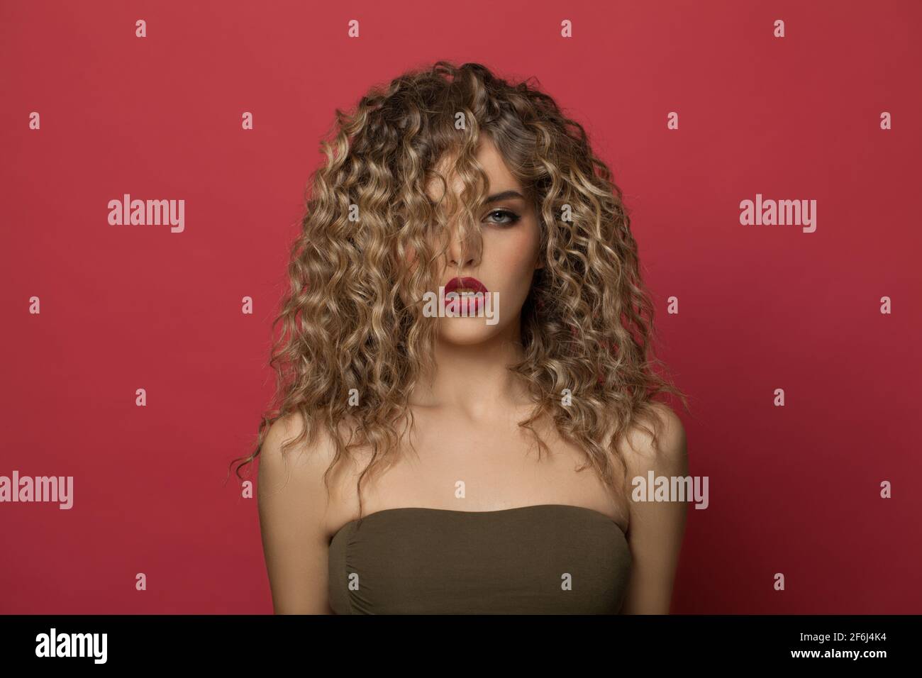 Stylish young woman with curly hair portrait Stock Photo - Alamy