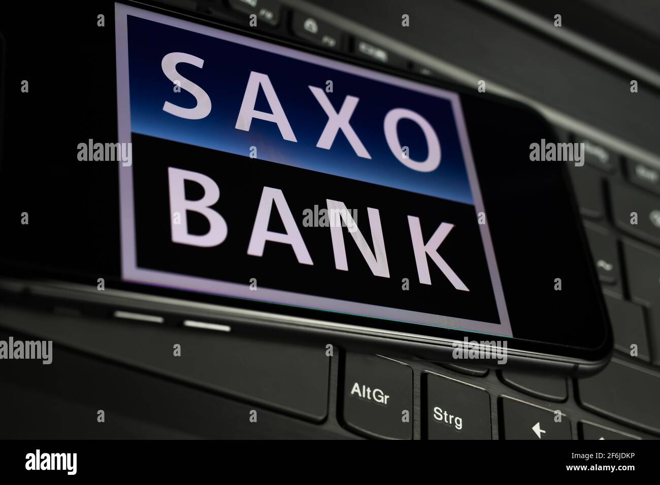 Viersen Germany March 1 2021 Closeup Of Smartphone Screen With Logo Lettering Of Online Broker Saxo Bank On Computer Keyboard Stock Photo Alamy