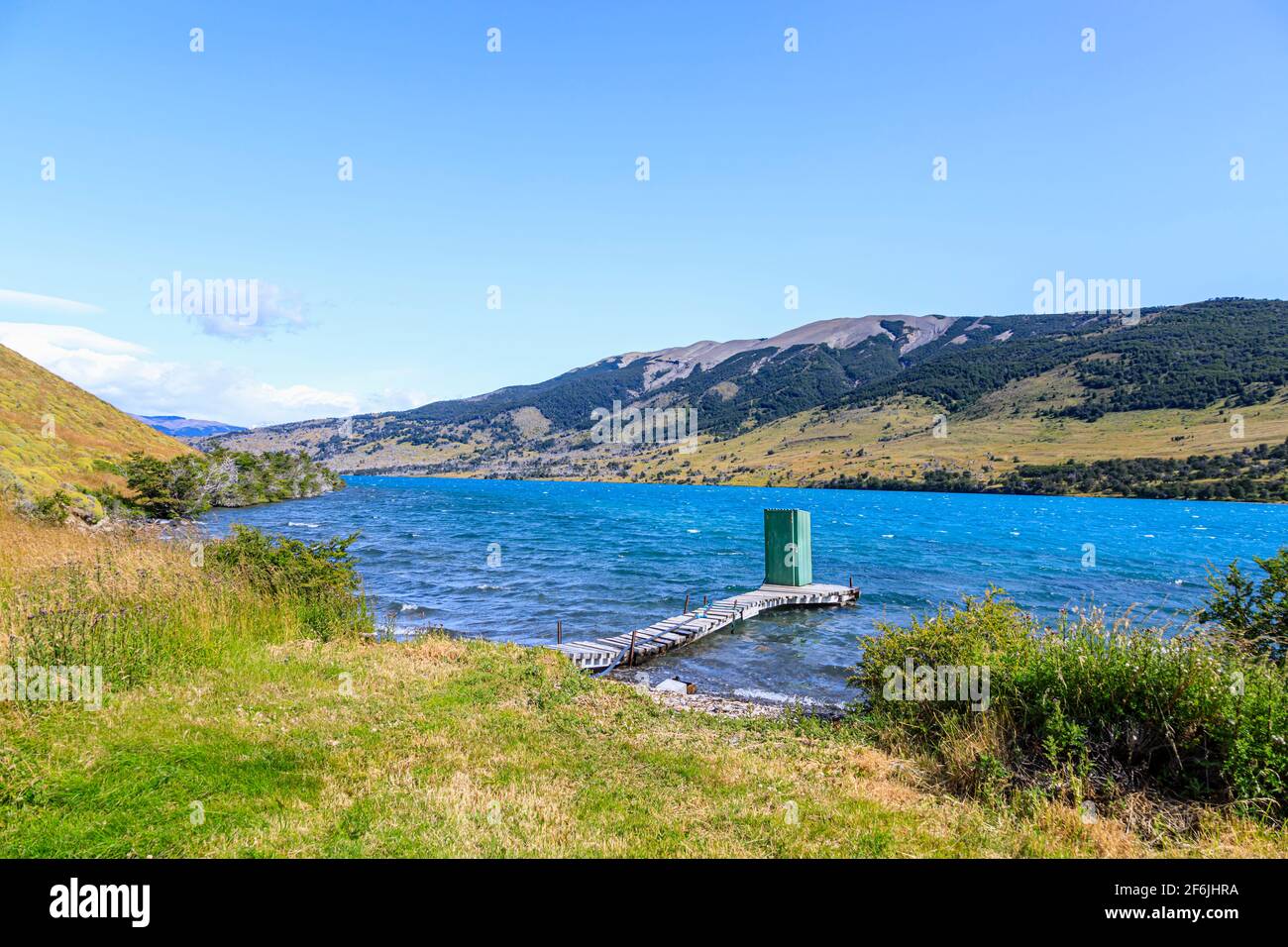 Green lakeside outdoor toilet shed standing at the end of a wooden jetty on Languna Azul, Torres del Paine National Park, Patagonia, southern Chile Stock Photo