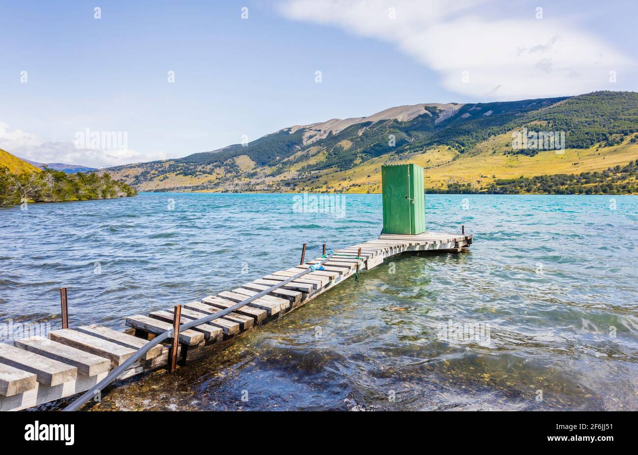 Green lakeside outdoor toilet shed standing at the end of a wooden jetty on Languna Azul, Torres del Paine National Park, Patagonia, southern Chile Stock Photo