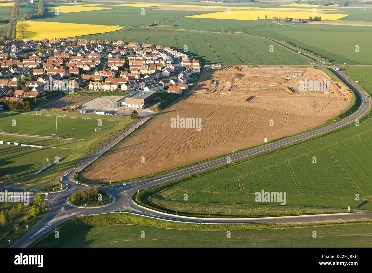 Aerial photograph of Ablis, roundabout and rapeseed fields in spring, located in the south of the Yvelines department, Île-de-France region, France. - Stock Image