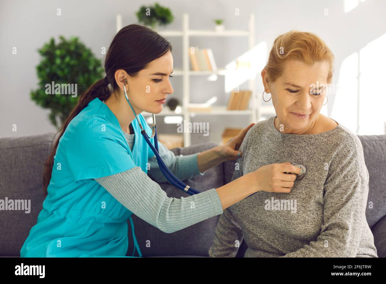 Doctor Checking Senior Patient S Heart Or Lungs During Home Visit Or Checkup At Clinic Stock Photo Alamy