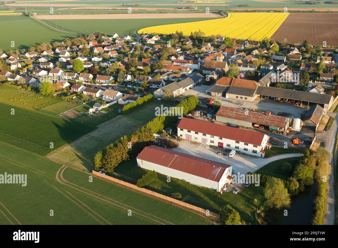 Aerial photograph of Boinville-le-Gaillard and rapeseed fields, located in the south of the Yvelines department, Île-de-France region, France. Municip - Stock Image
