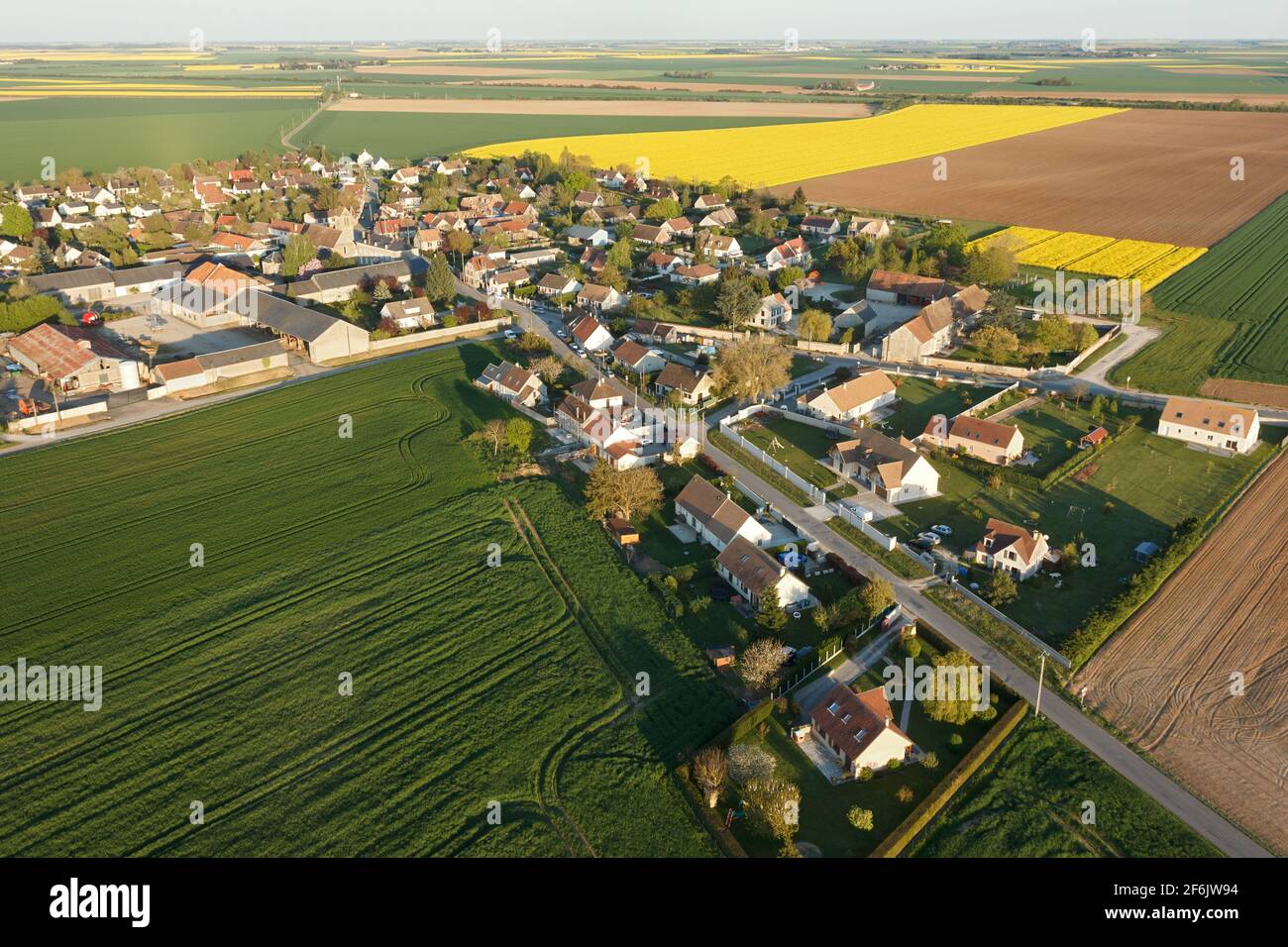 Aerial photograph of Boinville-le-Gaillard and rapeseed fields, located in the south of the Yvelines department, Île-de-France region, France. Municip - Stock Image