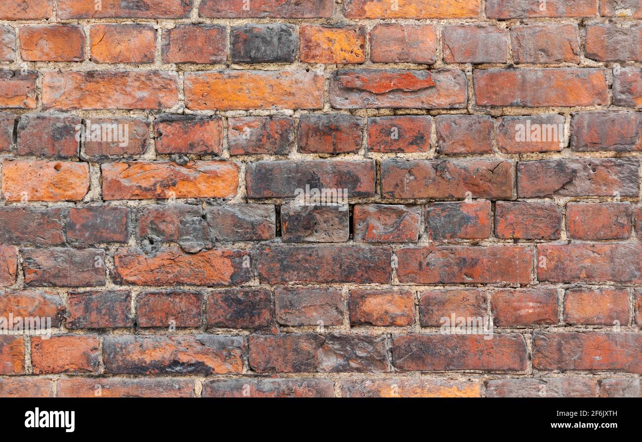 Seamless background photo of grungy red old brick wall, close-up photo texture Stock Photo
