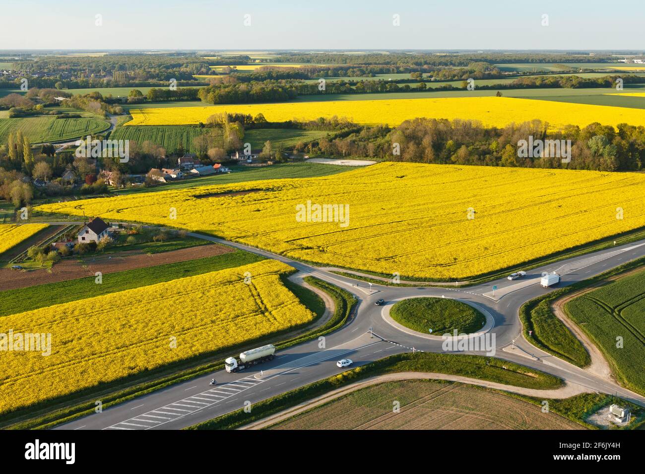 Aerial photograph roundabout and rapeseed in spring in Prunay-en-Yvelines, in the south of  Yvelines department, in Île-de-France region, France. - Stock Image