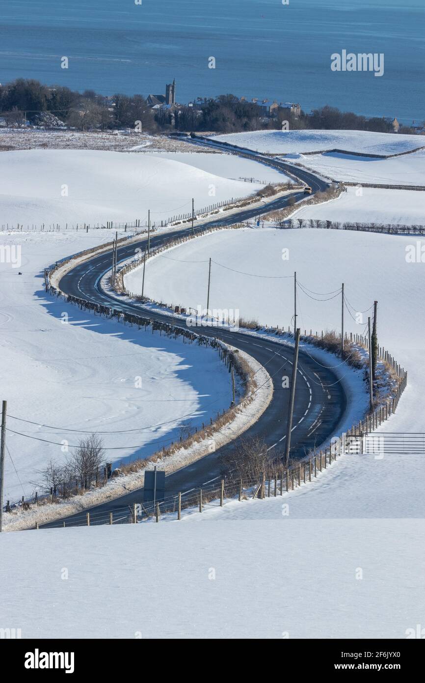 Snowy fields and a rural road leading to Burntisland, Fife, Scotland Stock Photo