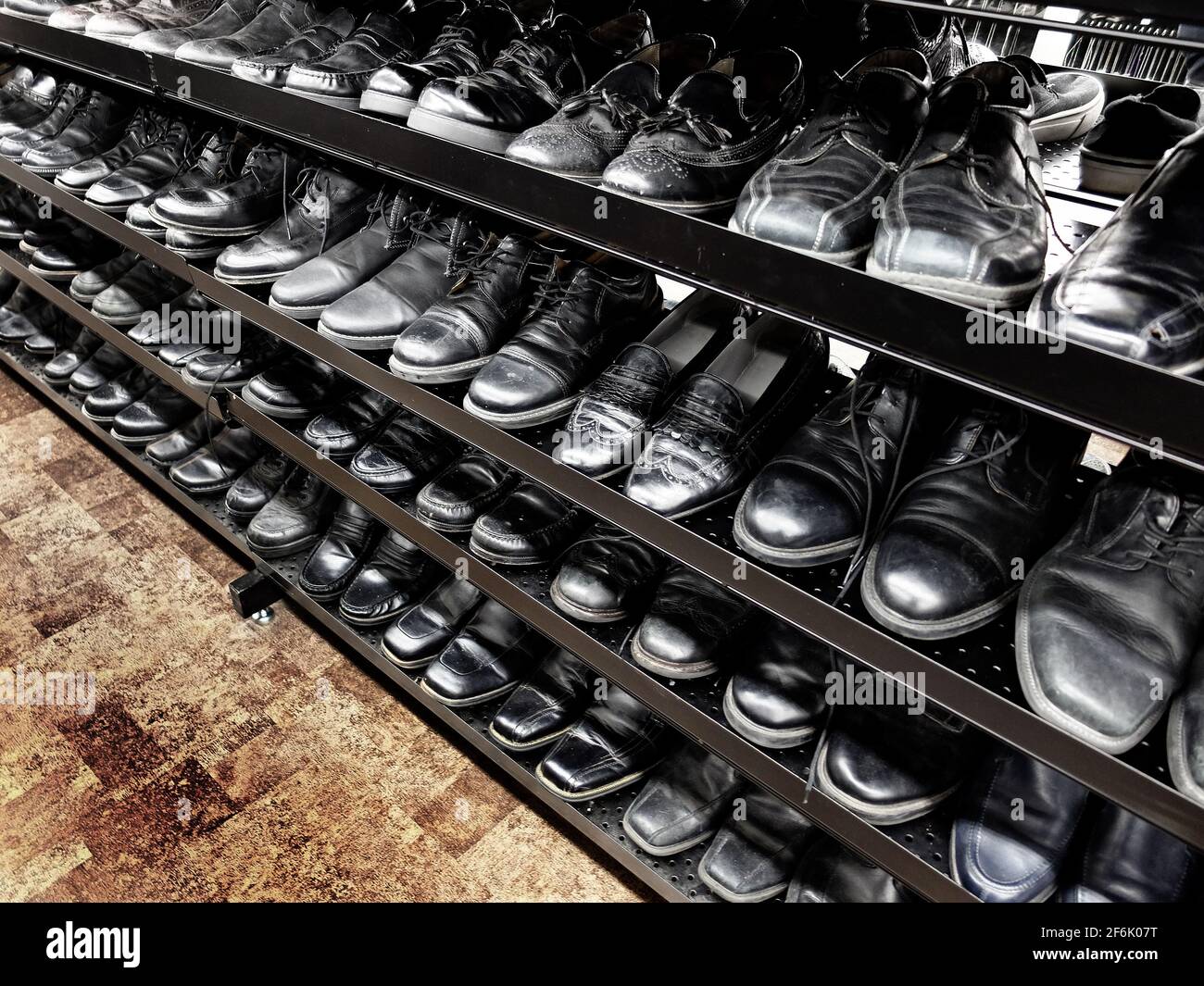 Rows of old mens men's dress shoes at thrift store on sale Stock Photo