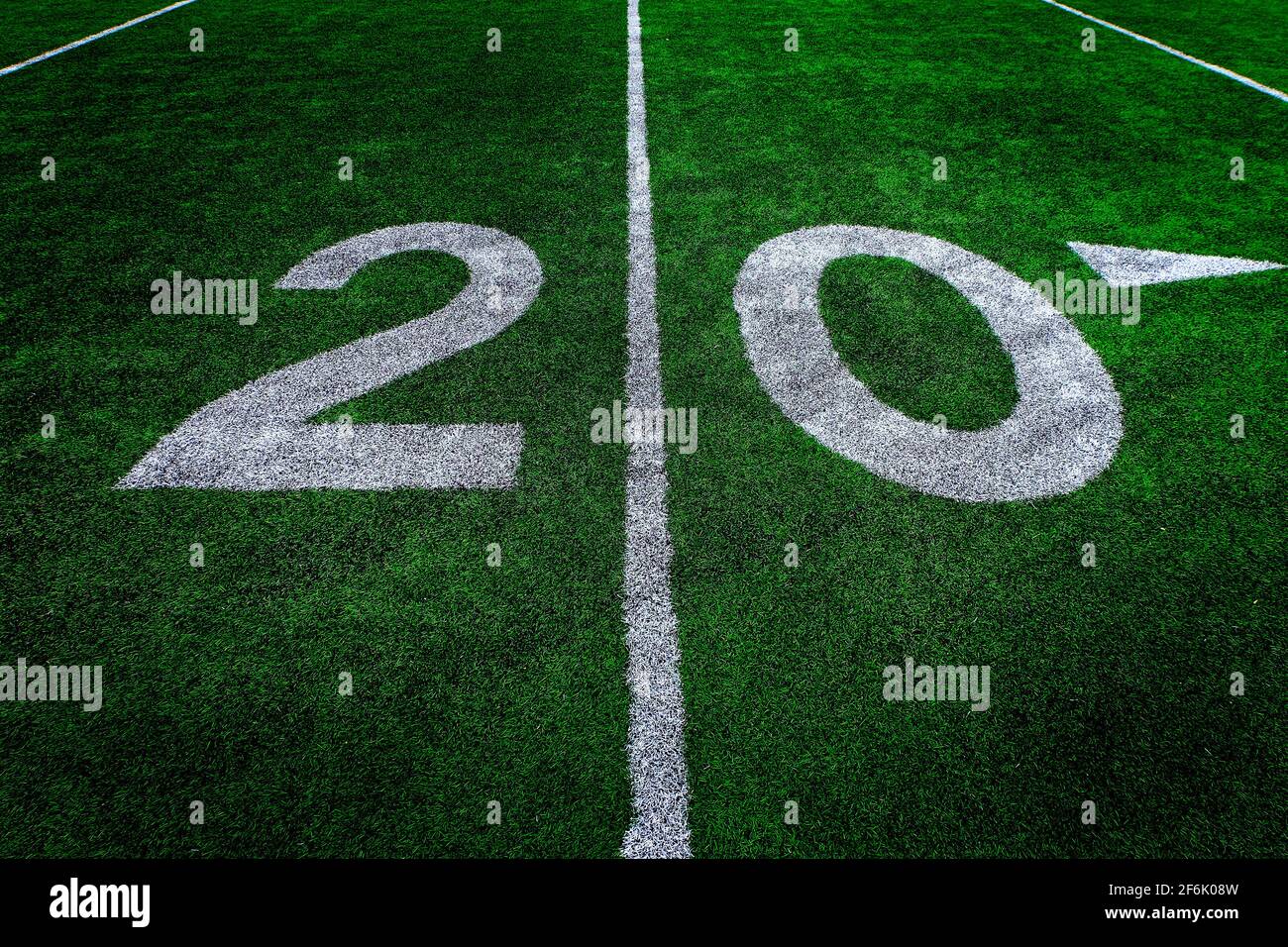 Football field green grass white yard markers to touchdown competition