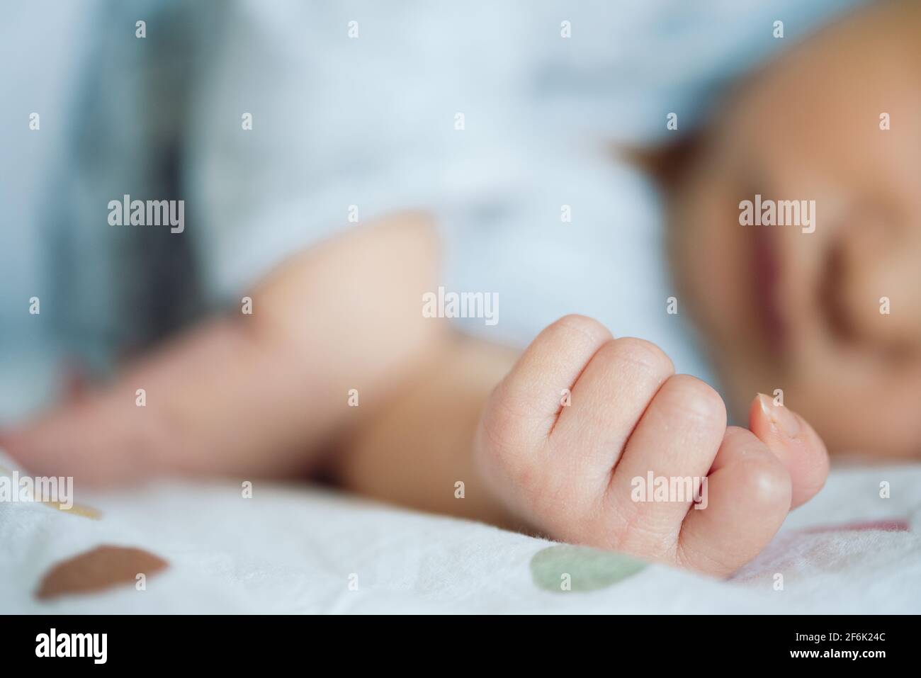 close-up view of hand of newborn baby resting on bed Stock Photo