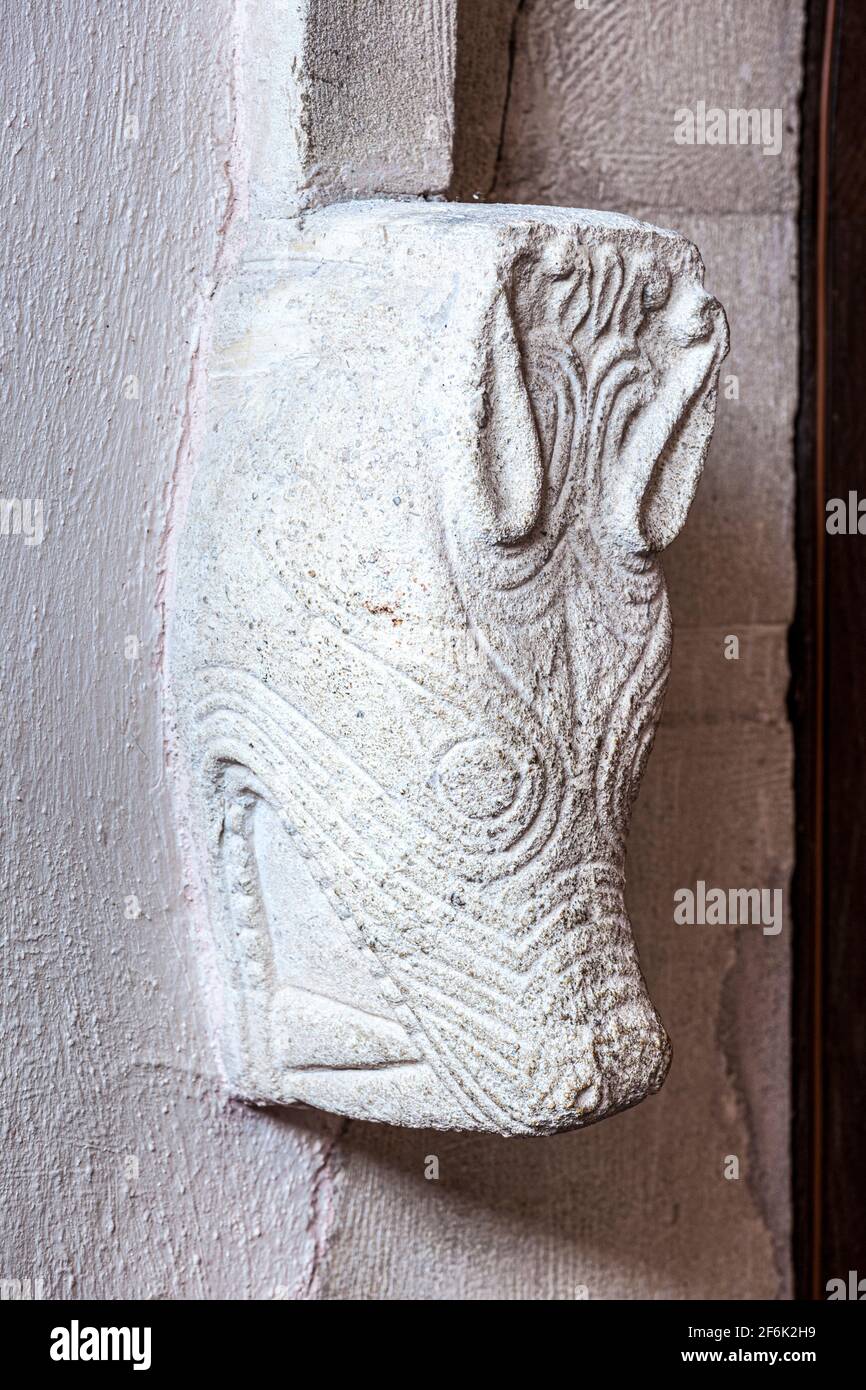 One of the Saxon beast heads beside the doorway in the Anglo-Saxon Priory Church of St Mary dating back to the 9th century at Deerhurst, Gloucestershi Stock Photo