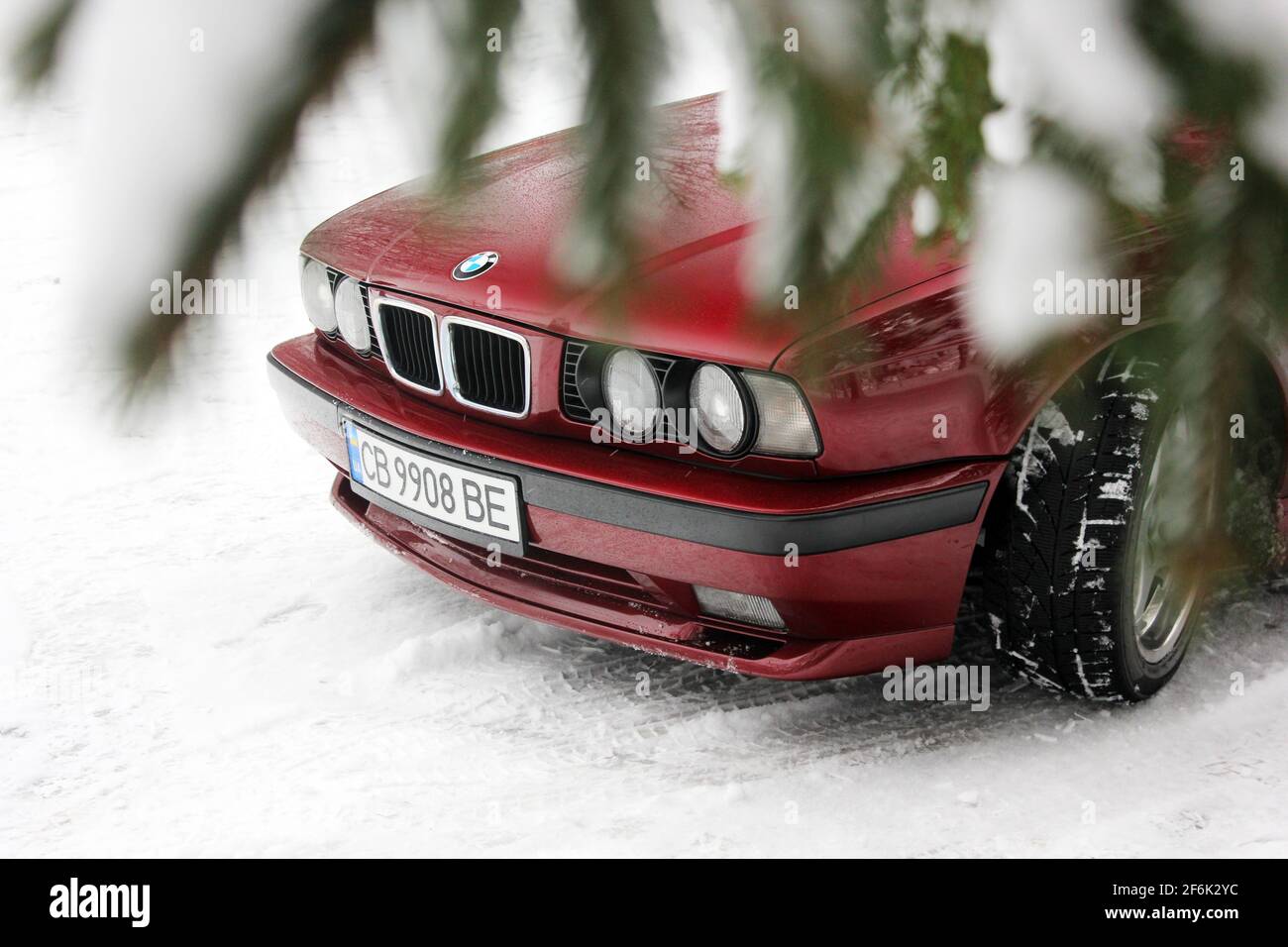 Chernigov, Ukraine - December 21, 2017: BMW 520 (E34) in the winter forest. Red BMW in a beautiful forest. Nature. Snow Stock Photo