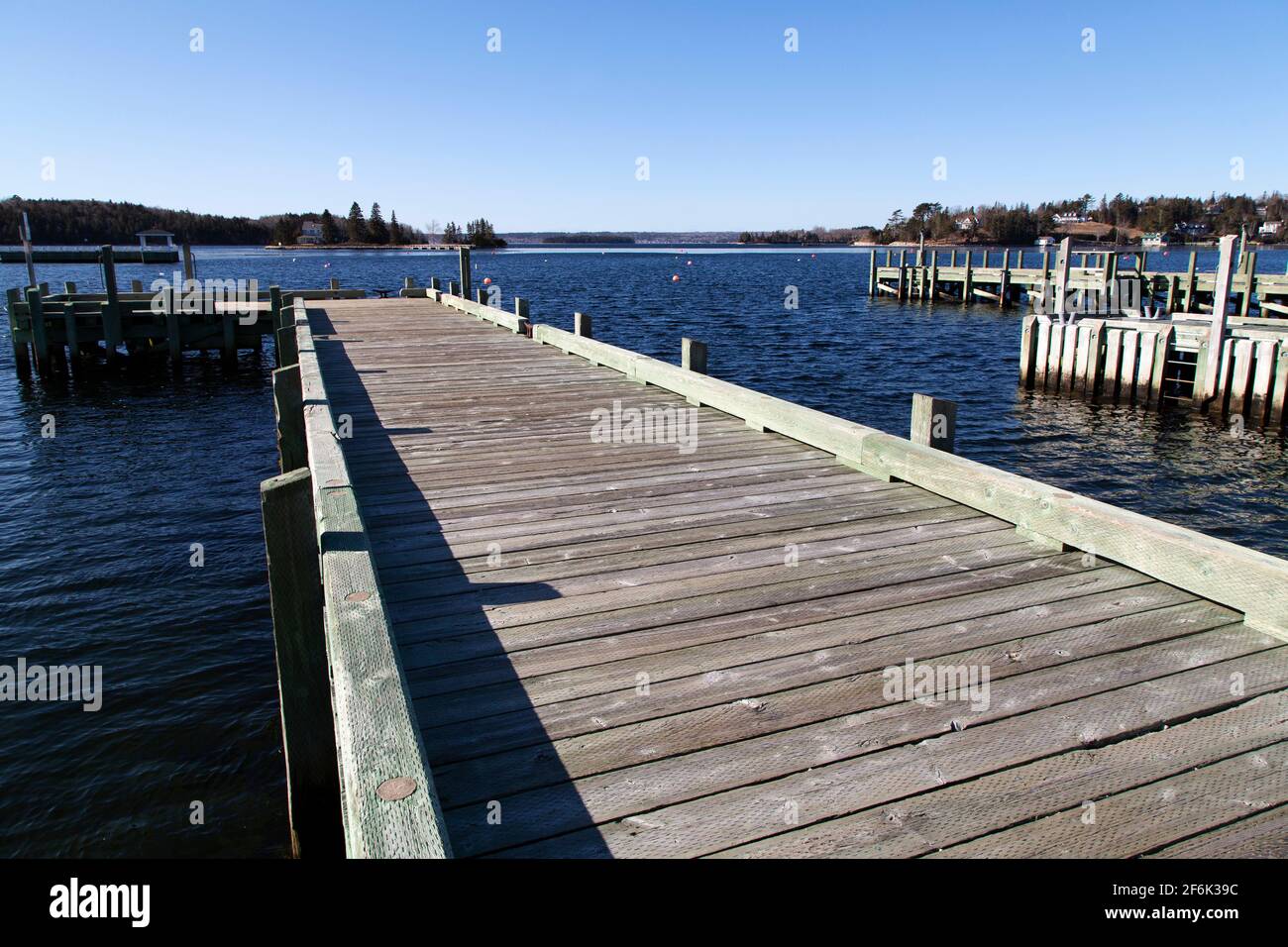 Wooden jetty at the waterfront in Chester, Nova Scotia, Canada. The jetty juts into the water of the harbour. Stock Photo