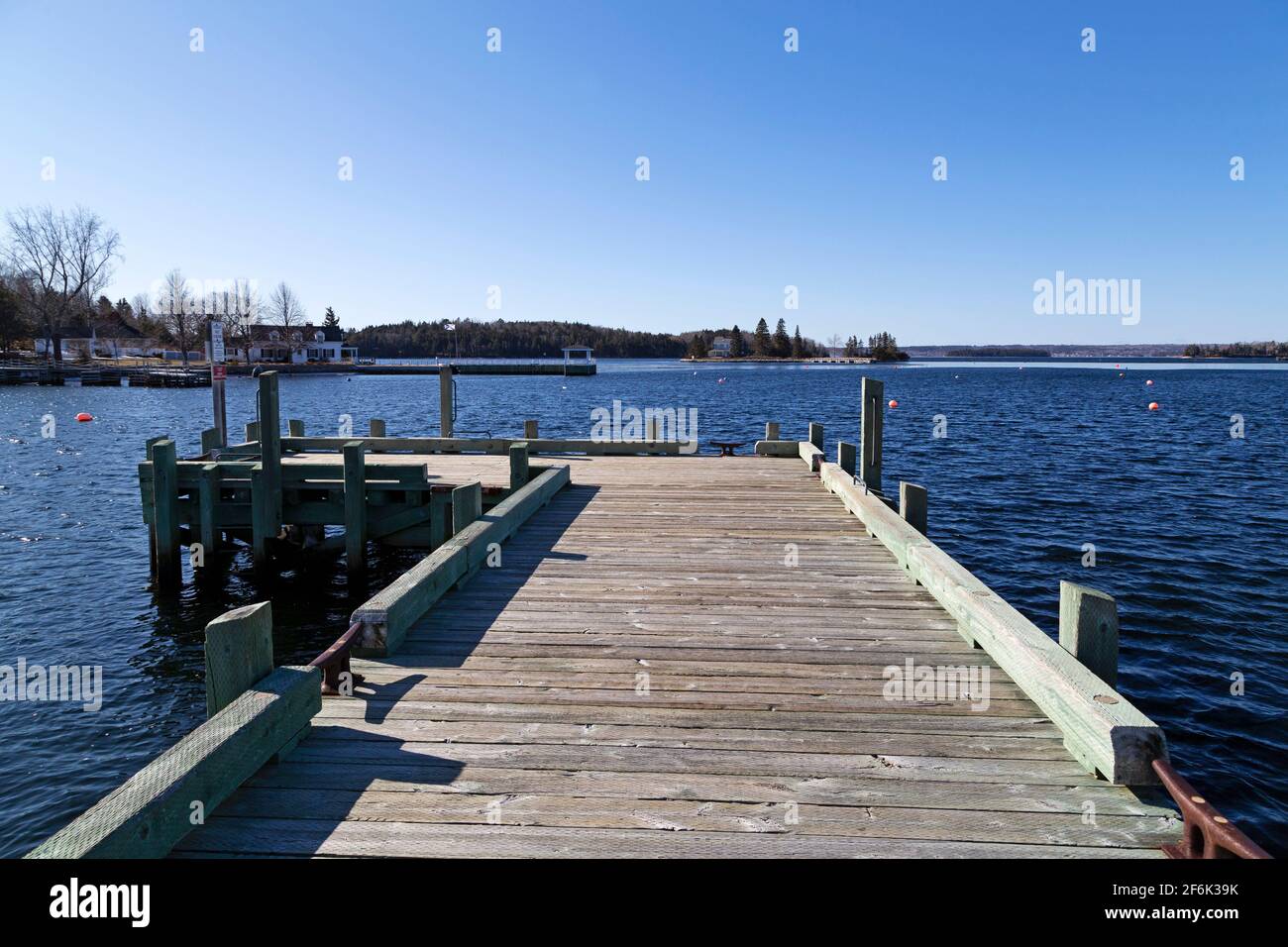 Wooden jetty at the waterfront in Chester, Nova Scotia, Canada. The jetty juts into the water of the harbour. Stock Photo