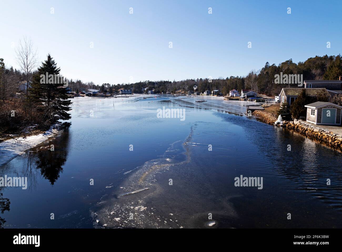 Mill Cove at Chester in Nova Scotia, Canada. The cove's water is partially frozen because of winter weather. Stock Photo