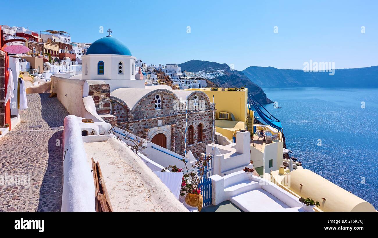 Greece, Santorini island. Scenic panoramic view with street and ancient greek church in Oia town Stock Photo