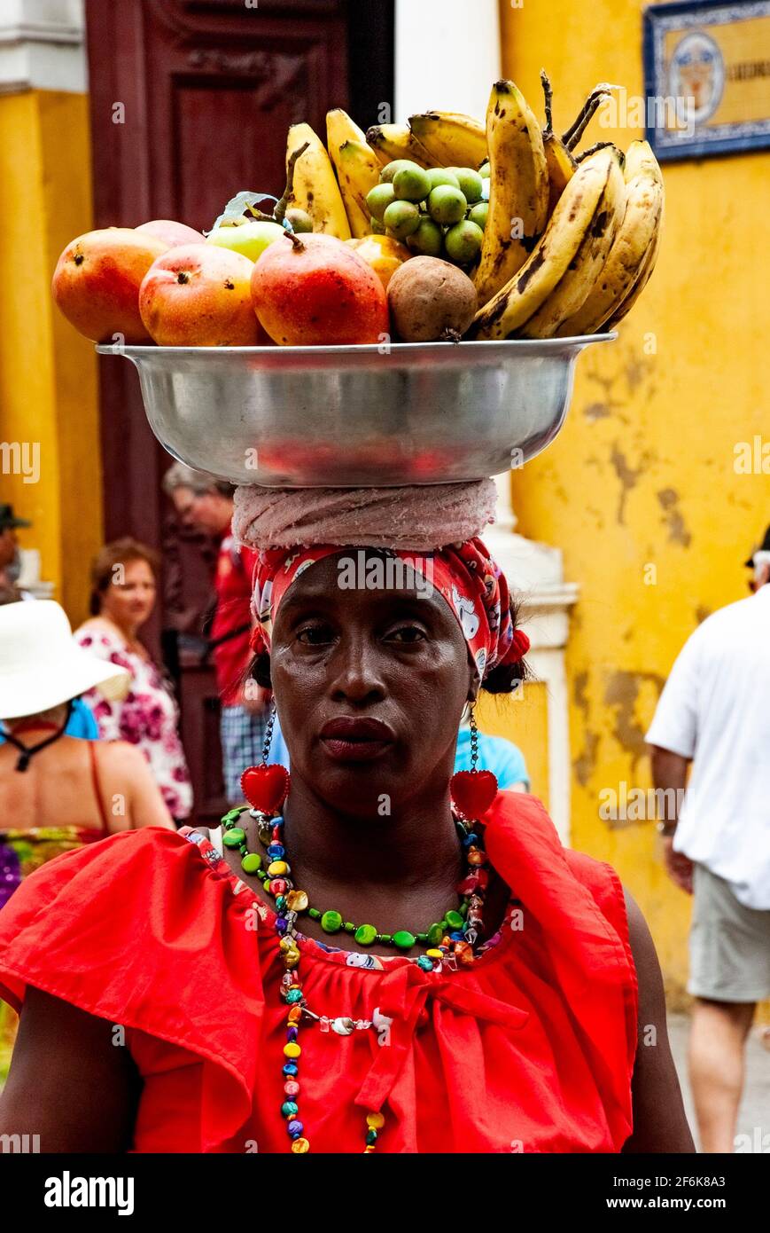 Cartagena, Colombia, Old Walled City Center centre, Centro, Playa de las Bovedas, shopping arcade. Woman in traditional costume selling fruit in the h Stock Photo