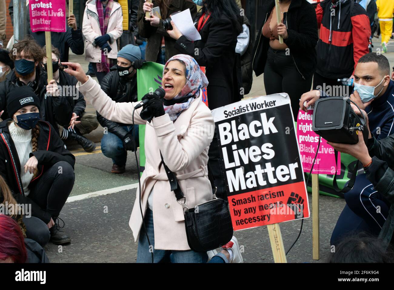 Kill the Bill protest Manchester, UK during the national lockdown in England. Demonstrator in front of a Black Lives Matter placard. Stock Photo