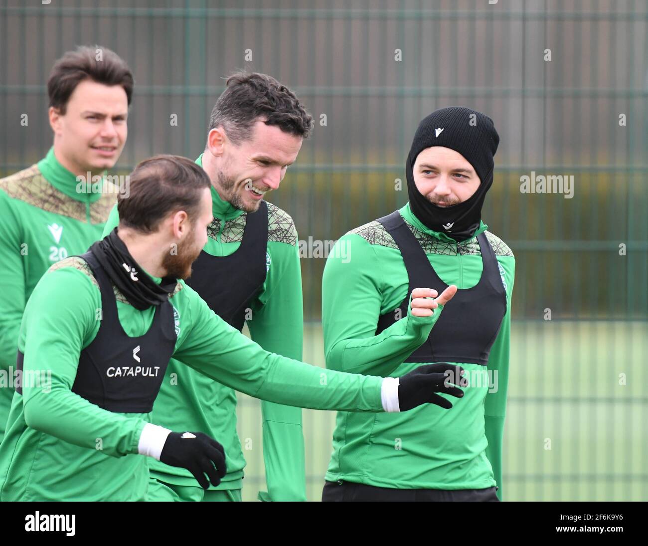 Tranent, Ormiston, East Lothian.Scotland. UK .1st April 21 Hibernian Paul McGinn (C) Shares joke with Martin Boyle (L ) & Drey Wright during training Session for the Scottish Cup game against Queen of the South. Credit: eric mccowat/Alamy Live News Stock Photo