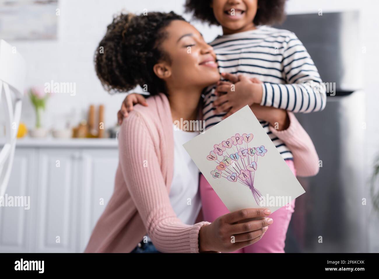 cheerful african american woman showing happy mothers day card while ...
