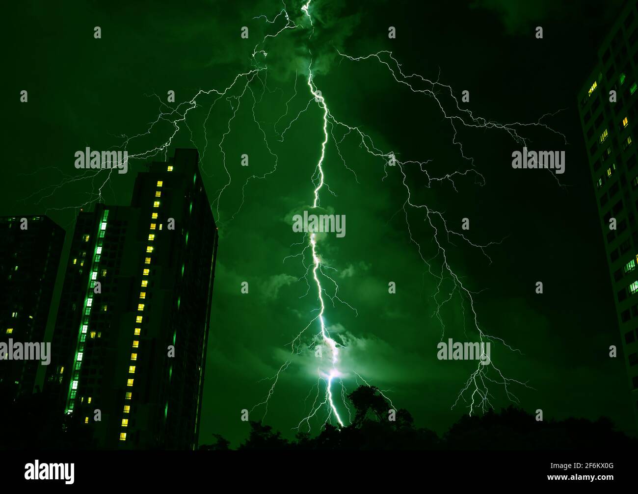 Pop Art Surreal Style Green Colored Lightning Strikes in the Urban Night Sky Stock Photo