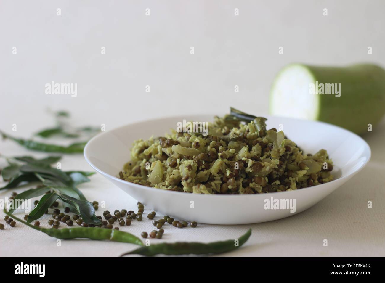 Stir fried Bottle gourd and green gram. A dish made with chopped vegetables and pulsed grated coconut with shallots, green chillies, turmeric and curr Stock Photo