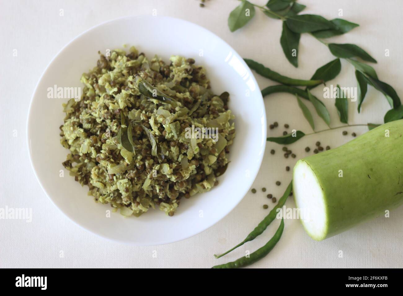 Stir fried Bottle gourd and green gram. A dish made with chopped vegetables and pulsed grated coconut with shallots, green chillies, turmeric and curr Stock Photo