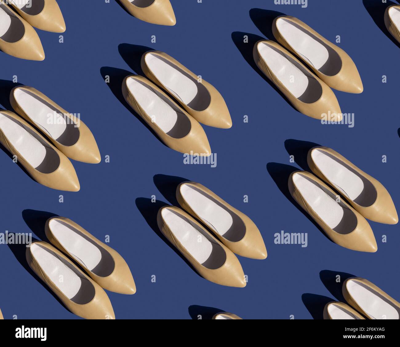 Pattern of women's beige leather shoes on a blue background Stock Photo