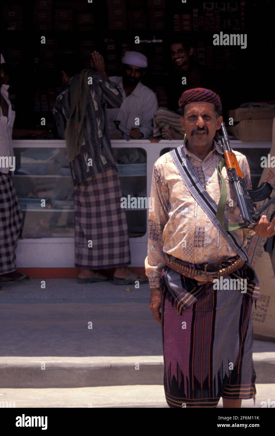 Yemeni posing with a Kalashnikov rifle in the market of Sanaa, Yemen Stock Photo