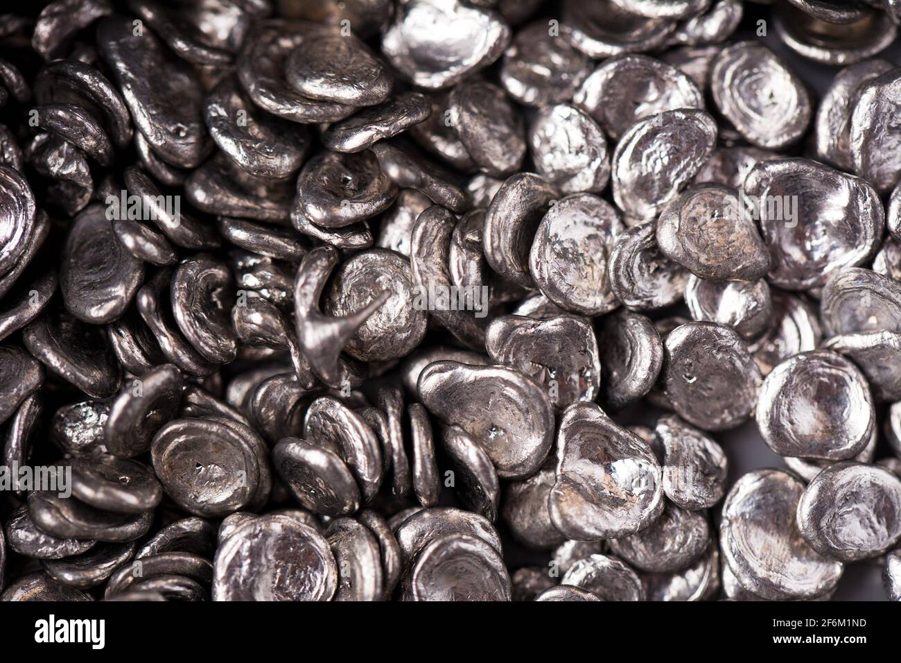 Rose alloy for soldering, silver background. Cast metal parts texture.  Closeup view. Selective focus Stock Photo - Alamy
