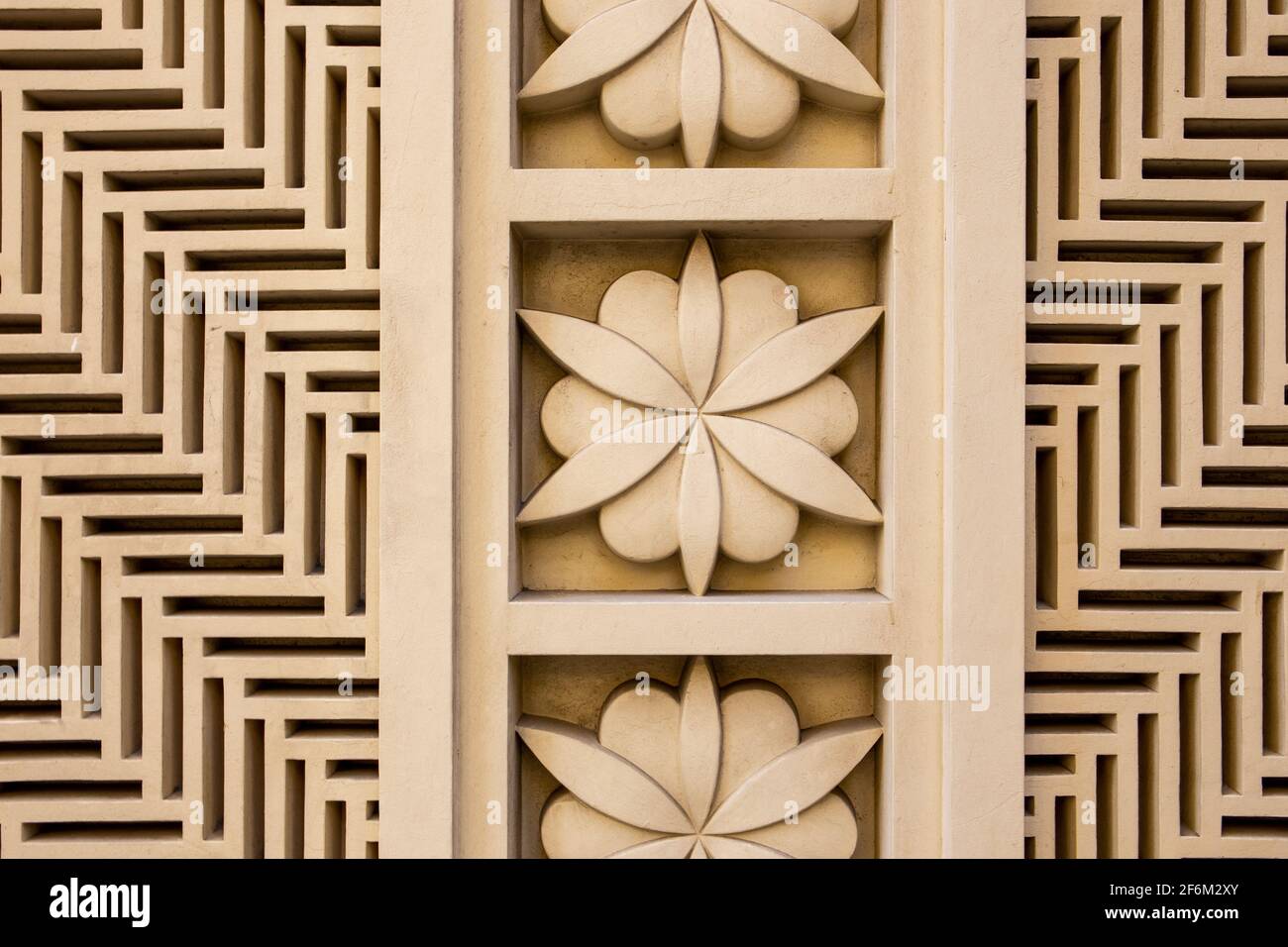 Arabic style carved stone openwork and relief, with floral patterns and geometric shapes and lines, on a building facade in Dubai JBR, UAE. Stock Photo