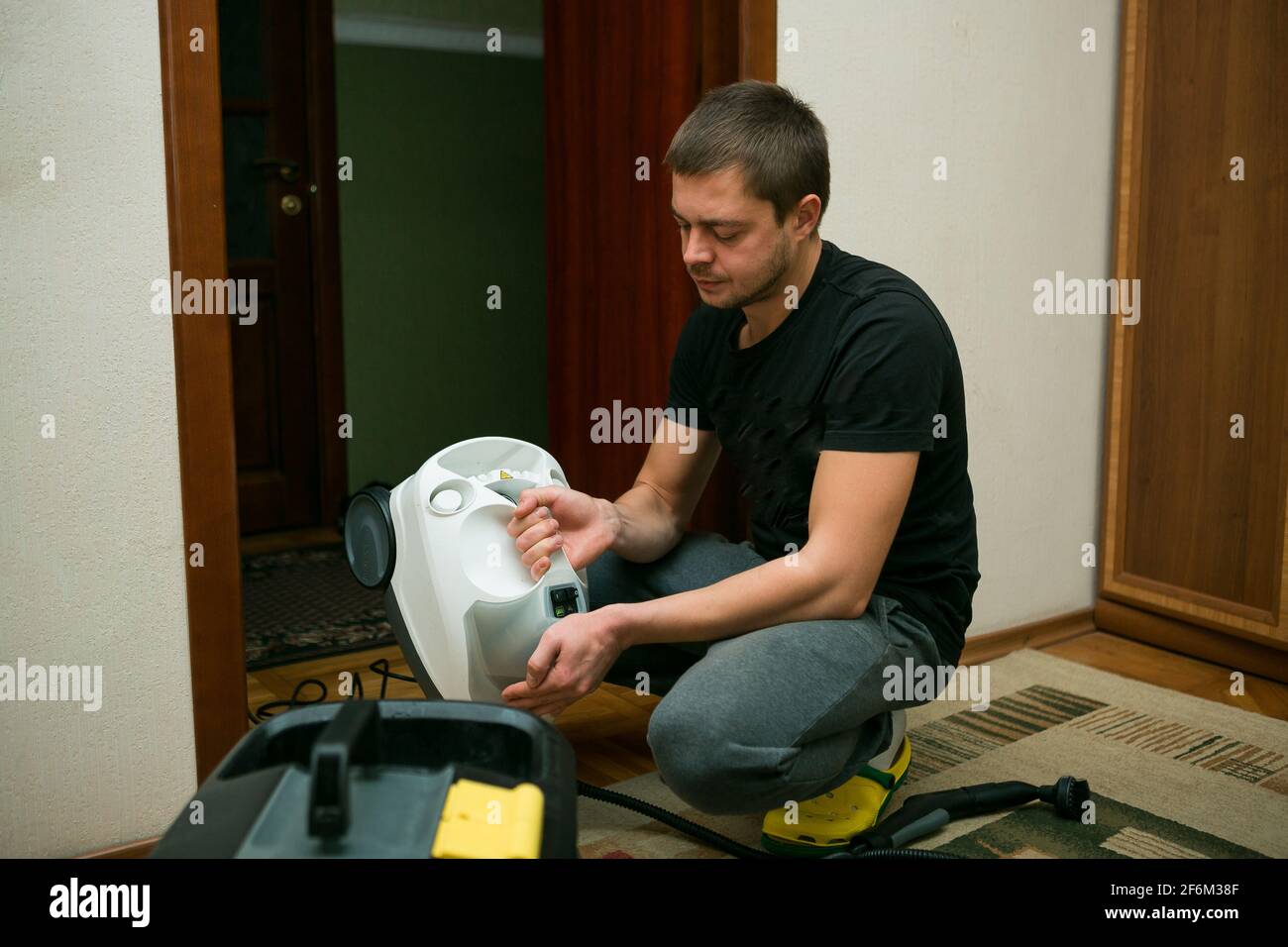 The process of cleaning carpets with a steam vacuum cleaner. An