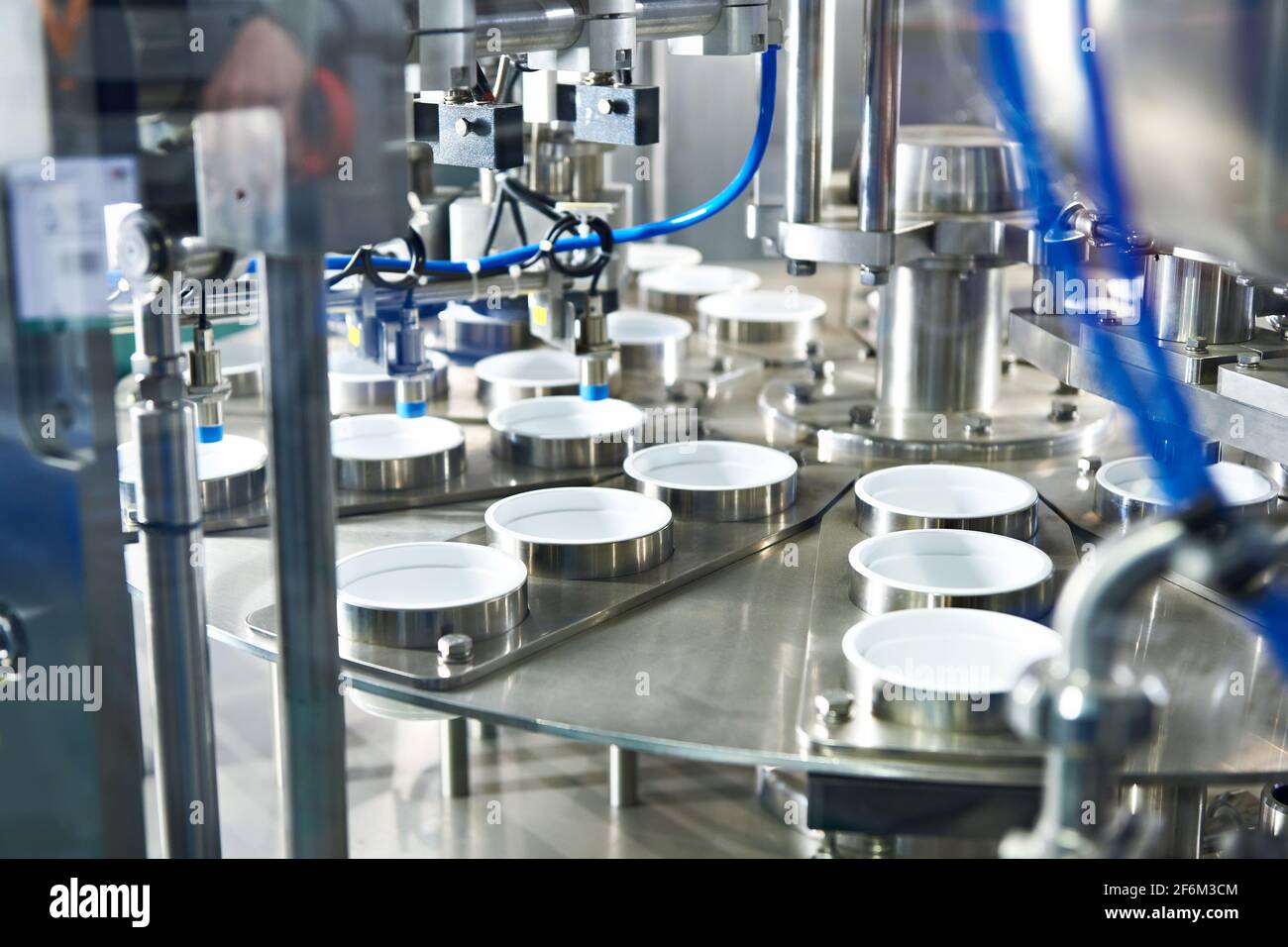 Conveyor at food factory for packing plastic containers Stock Photo