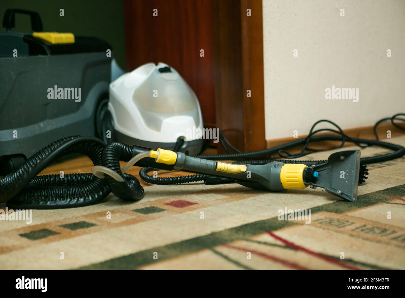 The process of cleaning carpets with a steam vacuum cleaner. The carpet ...