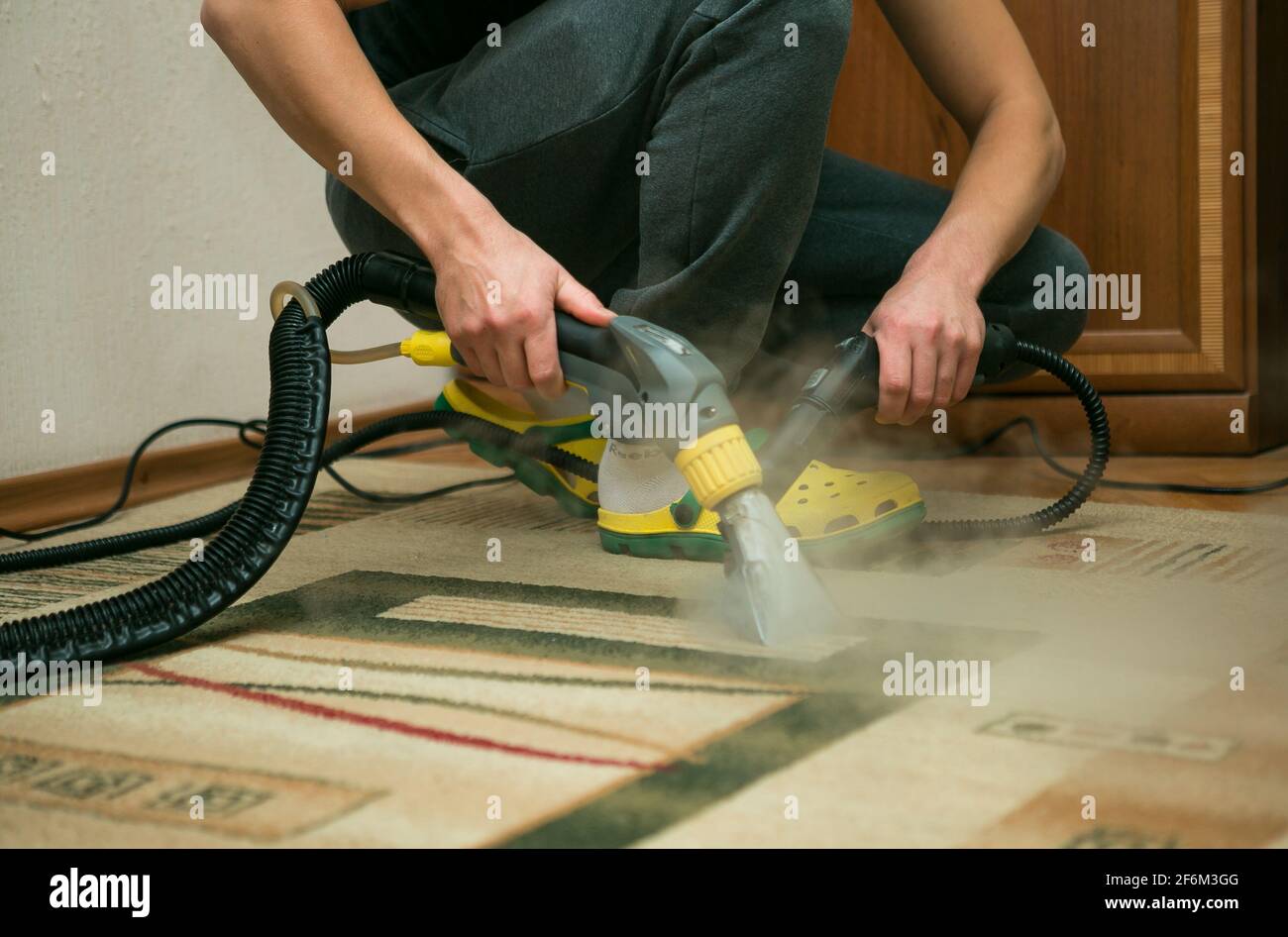 The process of cleaning carpets with a steam vacuum cleaner. An ...