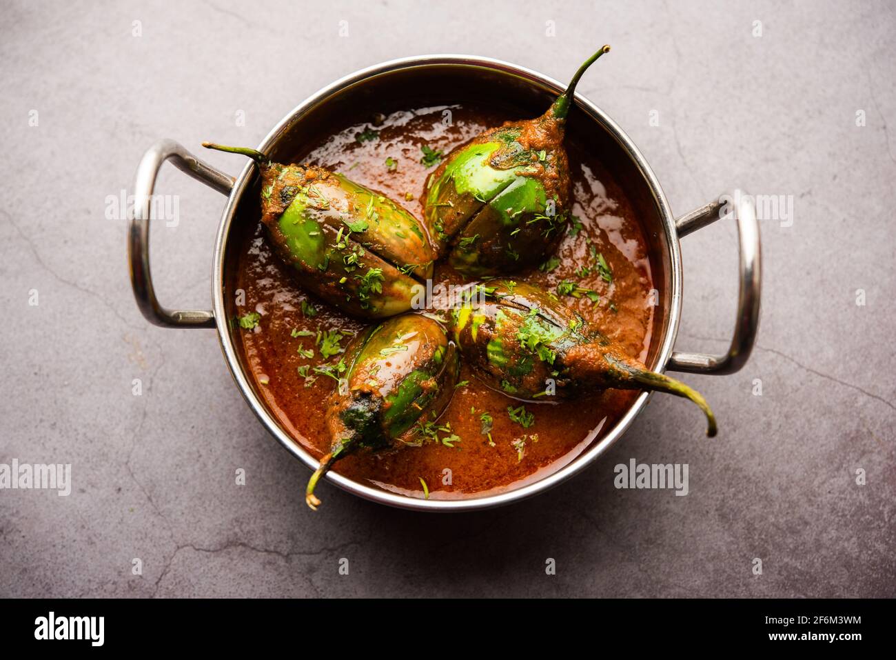 Brinjal curry also known as spicy baingan or eggplant masala, a popular main course recipe from India served in a bowl, karahi or pan Stock Photo