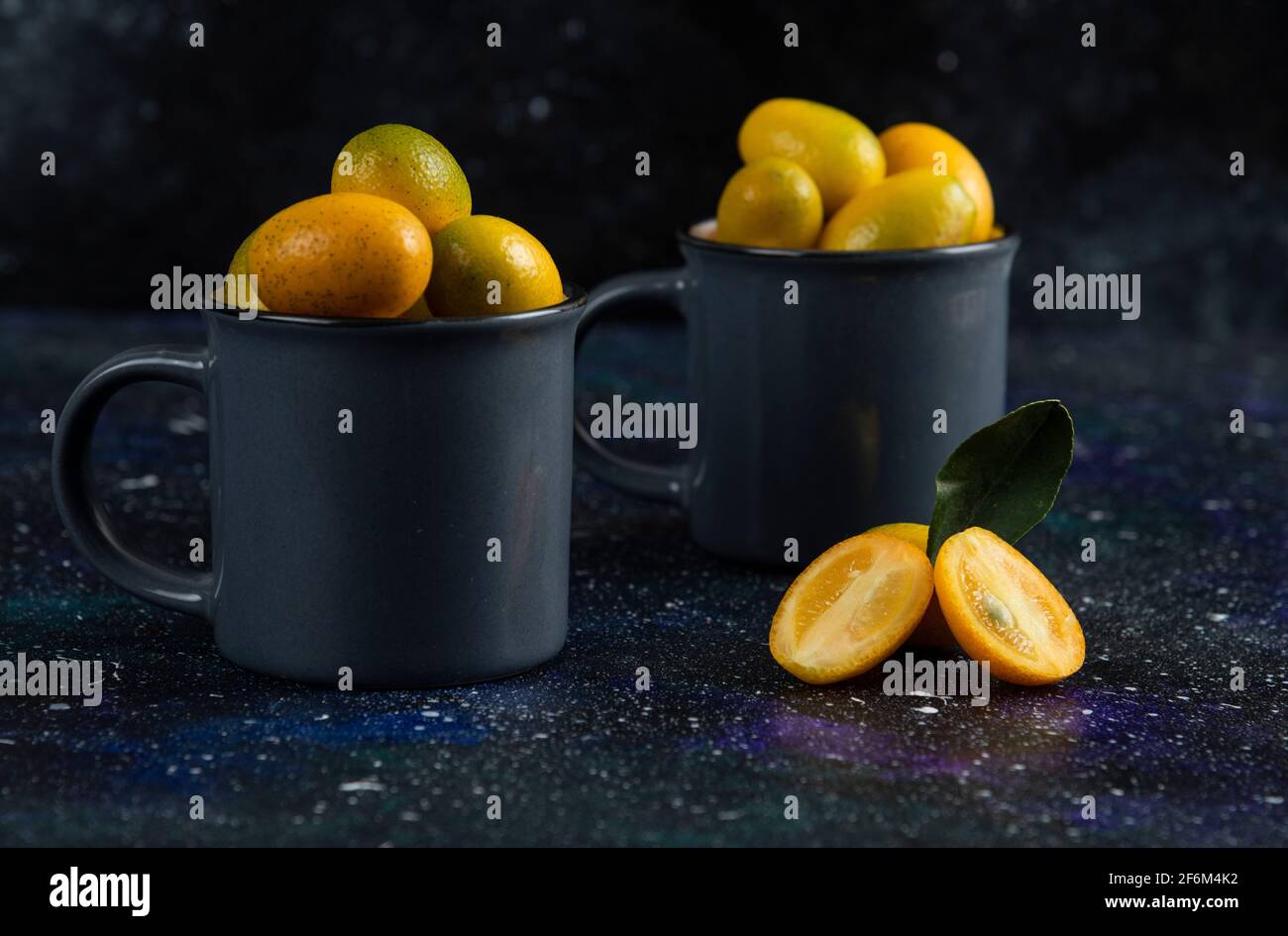 Close up photo of two cup full with organic kumquats Stock Photo