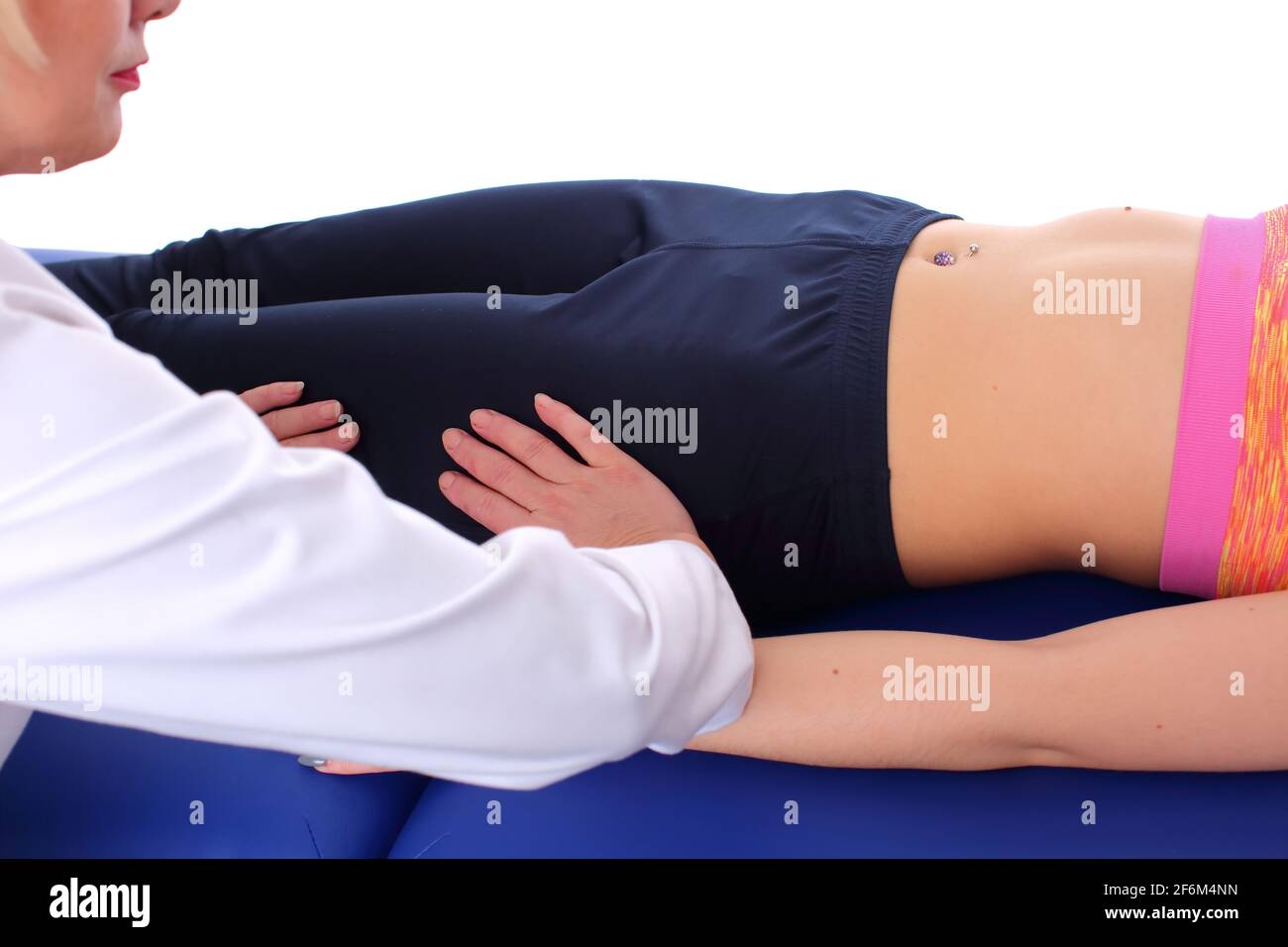 The physiotherapist performs a relaxing massage of the hip muscles by  gently rocking them from side to side Stock Photo - Alamy