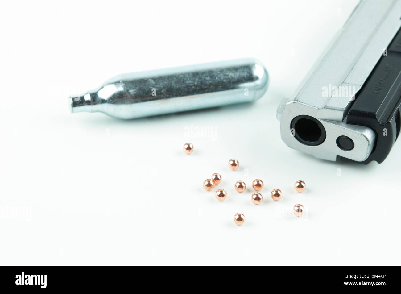Air Gun, Co2 Cartridges and Pellets Isolated on White Background. Focus