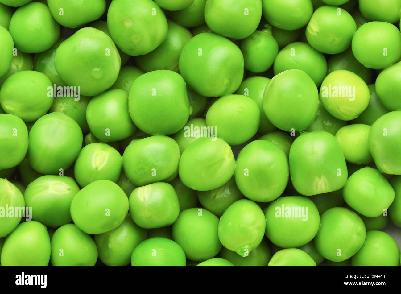 Fresh green peas background texture. Stock Photo