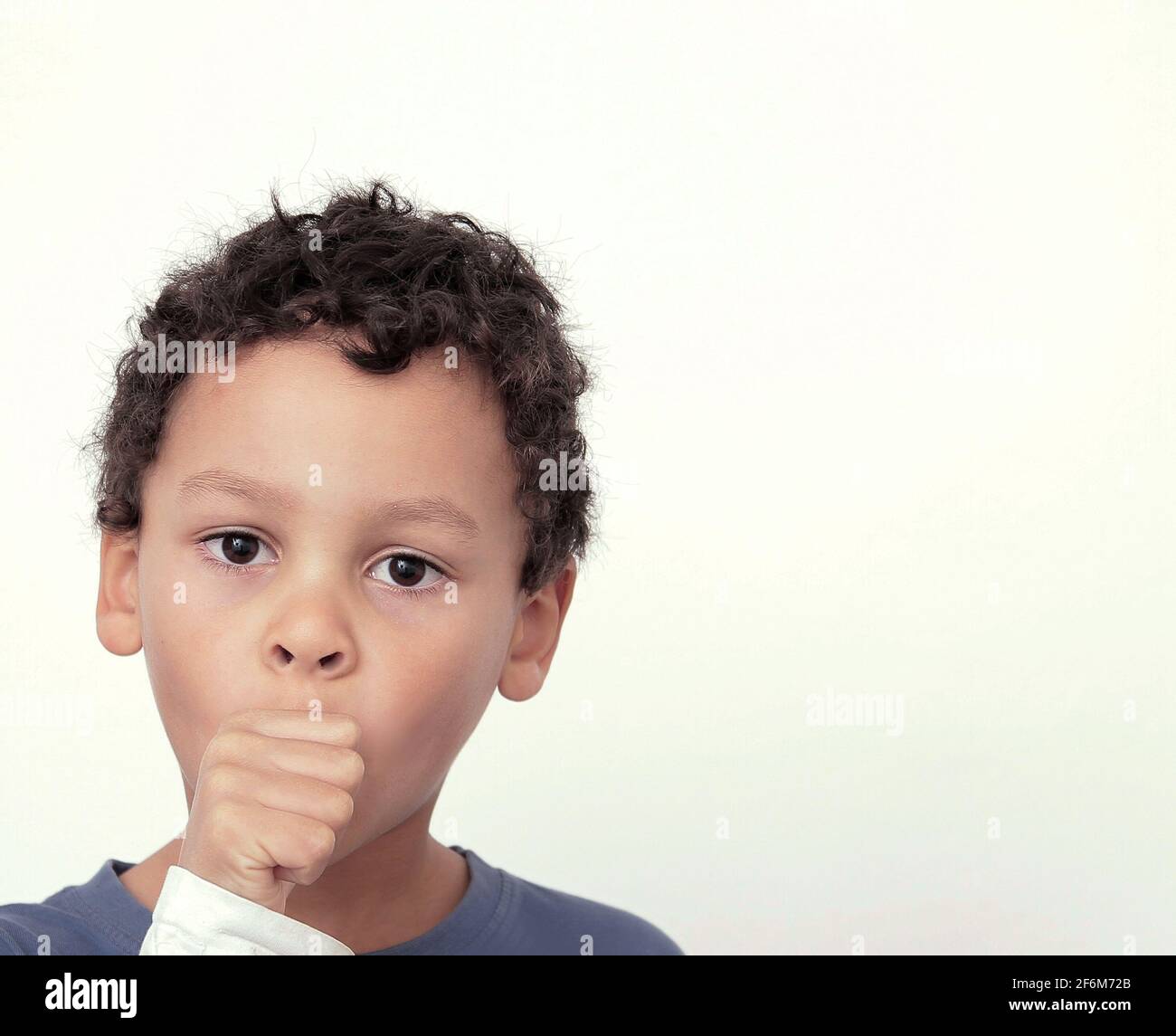 boy sucking thumb on white background stock photo Stock Photo