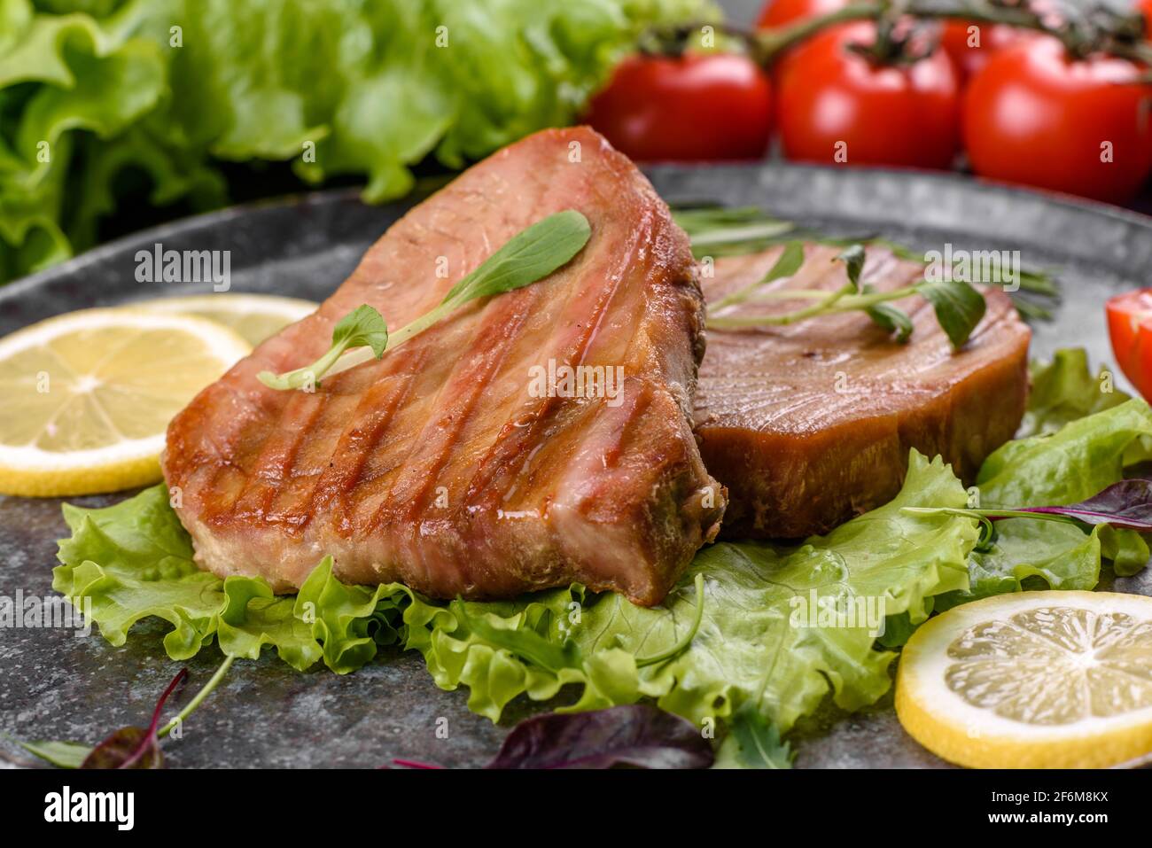 Delicious juicy tuna steak grilled with spices and herbs and lemon