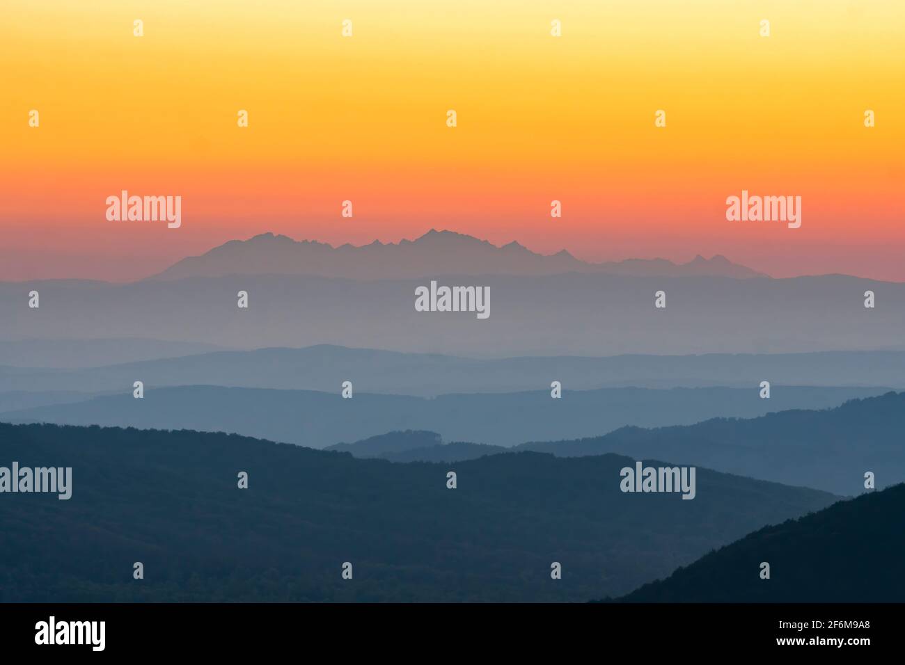 View of the sunset over the Tatra Mountains from the Jaslo peak in the Bieszczady Mountains. Poland, Europe Stock Photo