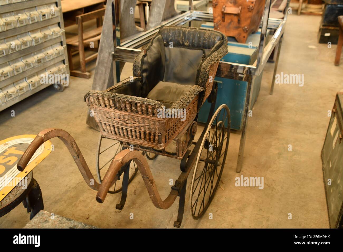 A modified Victorian pram, childs carriage, spotted in a reclamation warehouse in Somerset awaiting restoration. Stock Photo