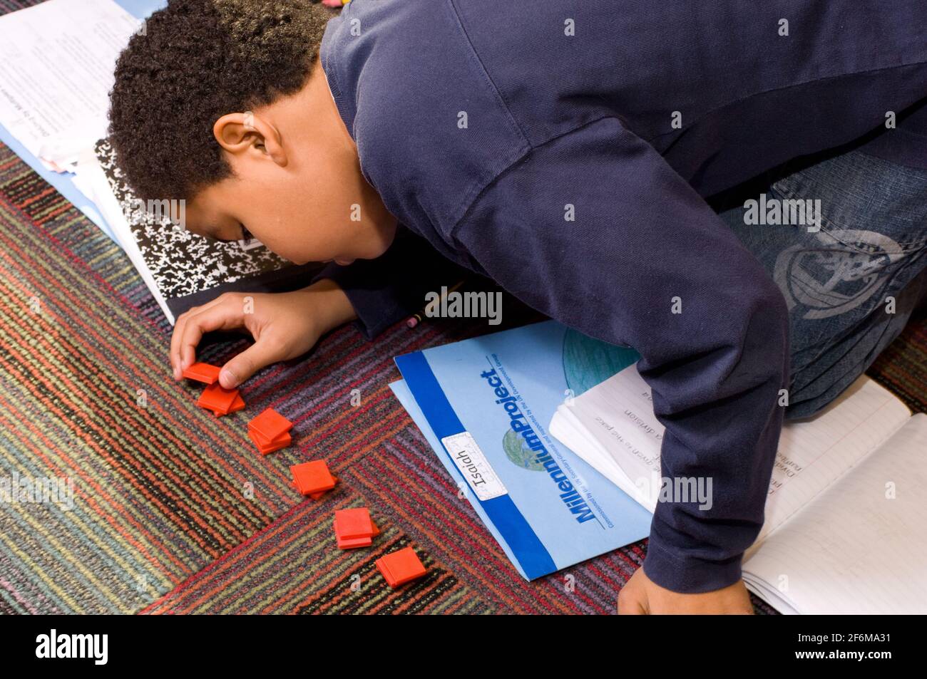 Independent elementary school Grade 4 ages 9-10 mathematics boy working with manipulatives Stock Photo