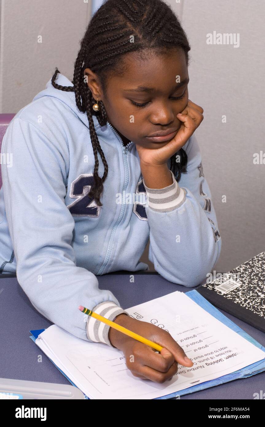 New york City independent elementary school Grade 4 ages 9-10 mathematics girl working on mathematics problems Stock Photo