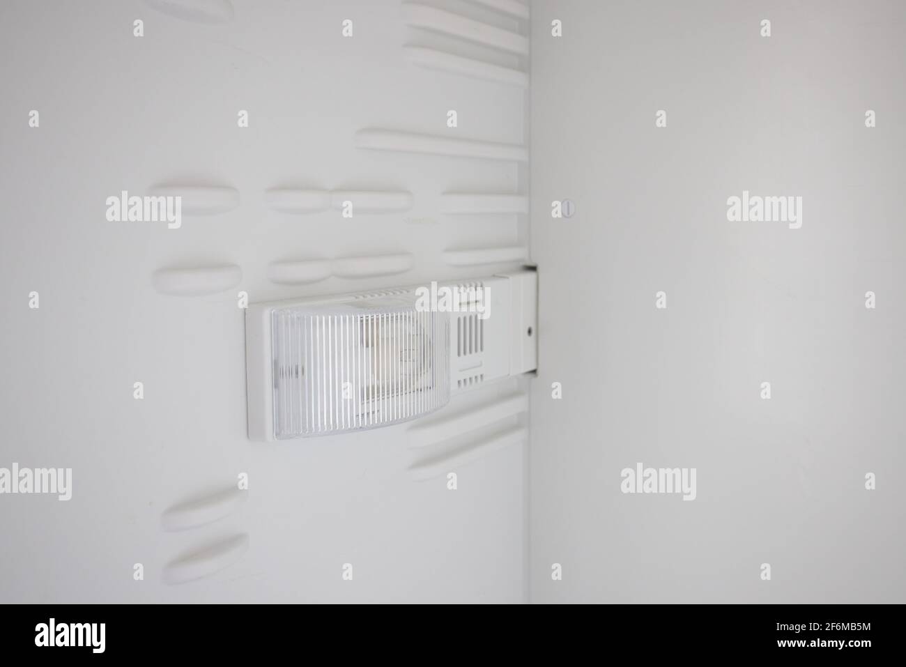 An empty refrigerator. Inside an empty, clean refrigerator, a refrigerator compartment after defrosting. Stock Photo