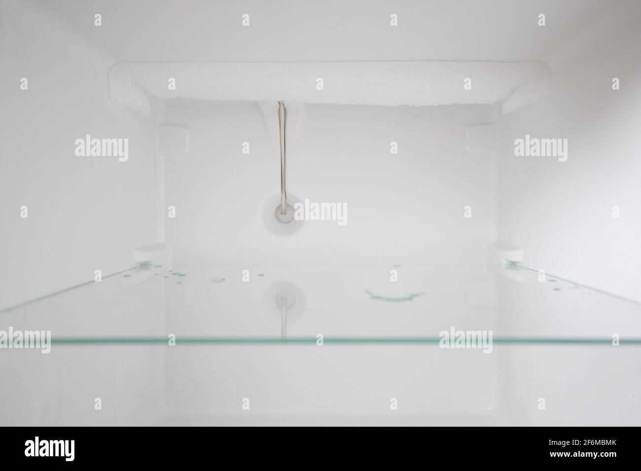 An empty refrigerator. Inside an empty, clean refrigerator, a refrigerator compartment after defrosting. Stock Photo