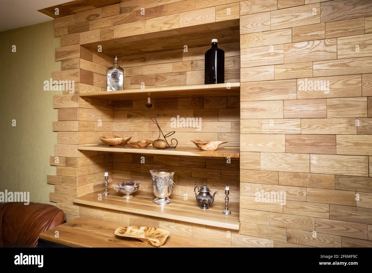 Walls covered with tiles made of valuable wood. Handmade wood products. Stock Photo